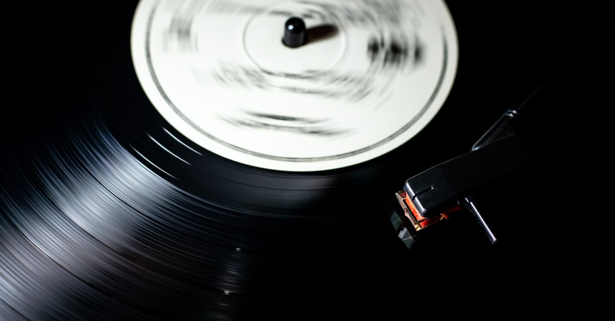 Close-up of a vintage vinyl record spinning on a turntable.